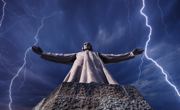 Statue of the Christ against the storm sky
