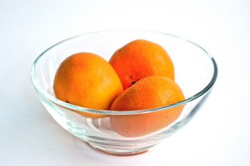 Tangerines in a bowl on a white background