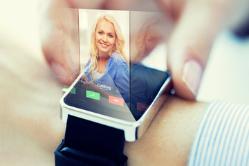 close up of hand with incoming call on smart watch