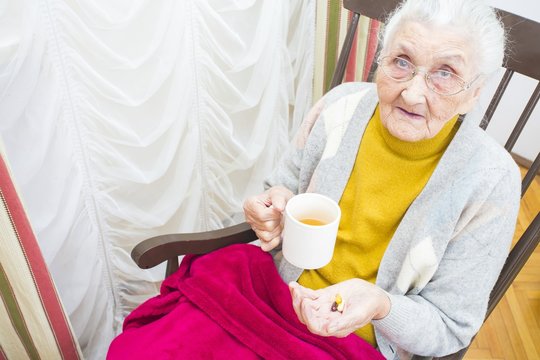 Elderly lady taking medication