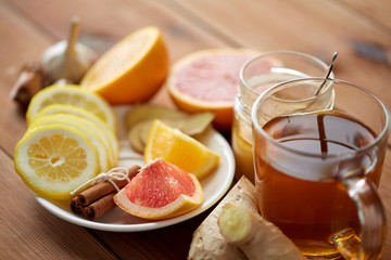 ginger tea with honey, citrus and garlic on wood