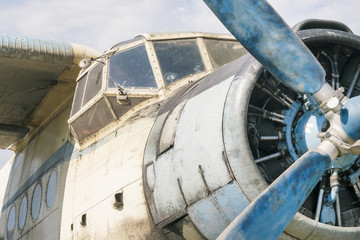 Part of a small blue and white plane on a background of blue sky