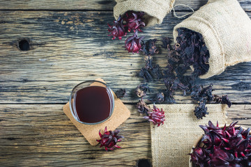 Fresh roselle, roselle dried and roselle juice on a wooden table. roselle plants that have medicinal properties and can also make a tasty roselle juice.