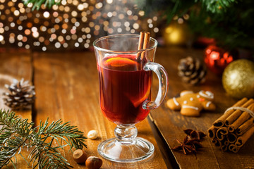 Mulled wine for Christmas Eve celebration party by Christmas tree. Hot traditional winter drink for New Year eve.