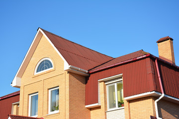 Fototapeta na wymiar Attic construction outdoor. Attic roof exterior with asphalt shingles. Roofing Construction.