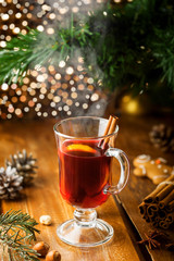 Mulled wine with citrus fruits and cinnamon on a table. Traditional winter hot drink for Christmas Eve party.