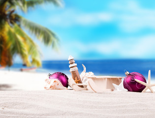 Christmas balls, ornament on a beach - concept of a warm weather Christmas celebration