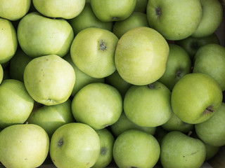 Background of green apples close up. Green apples pattern on sale at the market.