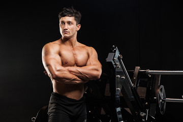 Fototapeta na wymiar Sexy muscular man posing in gym, shaped abdominal.