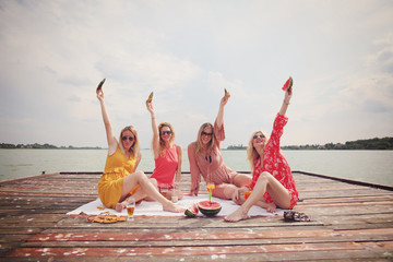 Women enjoying beautiful summer day at lake
