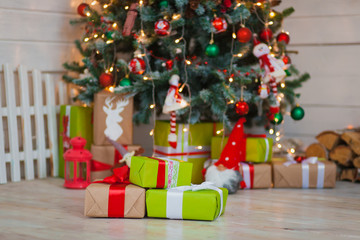 Fototapeta na wymiar Christmas gifts on the background of trees
