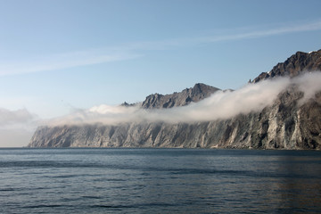 Fototapeta na wymiar Rocky shore of the Okhotsk sea in the morning mist.