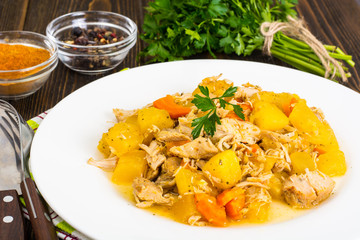 Vegetable stew with meat on a brown background