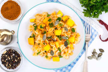 Farfalle with slices of pumpkin and parsley