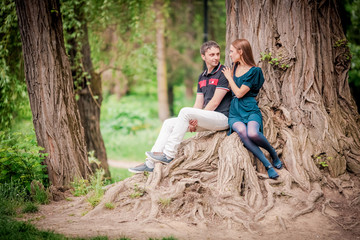 loving couple standing under a large tree holding hands