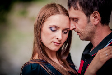 Young couple in love outdoor.Stunning sensual outdoor portrait of young stylish fashion couple posing in summer in field