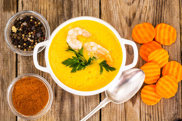 Sharp spicy vegetable cream soup with prawns