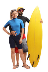 Young surfers posing with a surfboard