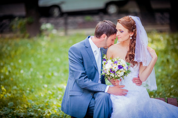 Elegant bride and groom posing together outdoors on a wedding day