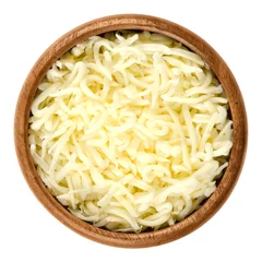 Fotobehang Shredded mozzarella pizza cheese in wooden bowl over white. Cheddar like semi hard Italian cheese made from milk, covered with corn starch. Isolated macro food photo close up from above. © Peter Hermes Furian