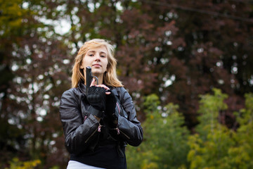 Nice girl with arms in autumn day