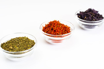 Basil, Saffron, Mint in a Glass Bowl on a White
