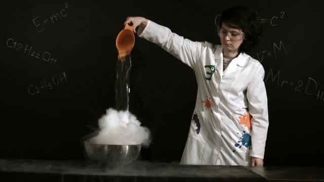 Powerful chemical reaction. Water reacts with liquid nitrogen with the separation of huge amount of vapor
