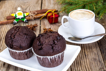 Chocolate Muffin with Coffee and Christmas Tree Background