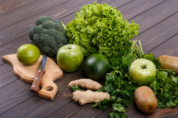 healthy green vegetables and fruits for smoothie lie on the tabl