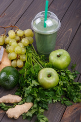 healthy smoothie with green vegetables and fruit lie on the tabl