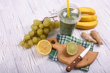 green smoothie with bananas,lime,grape and avocado lie on the ta