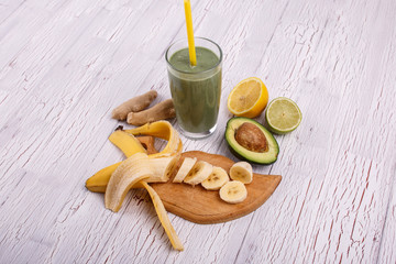 healthy smoothie with bananas,avocado,lime and ginger lie on the