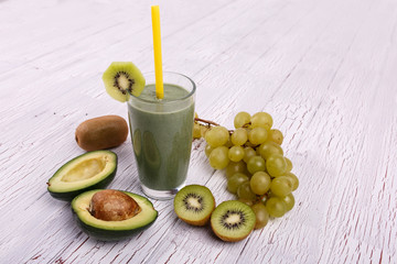 healthy smoothie with grape,avocado and kiwi lie on the table