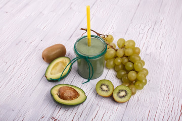 healthy smoothie with grape,avocado and kiwi lie on the table
