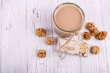 healthy brown smoothie with walnuts lie on the table