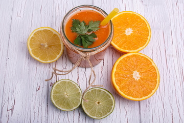 Fototapeta na wymiar orange detox coctail with half orange,lemon and lime lies on tab