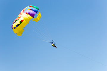 Parachuting above the sea, skydiver