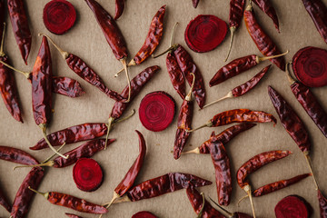 Dried red hot chilli peppers on craft paper background.