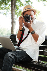 Hipster makes photo in park