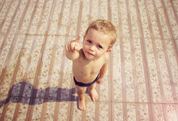 Fototapeta premium Boy in swimwear pointing