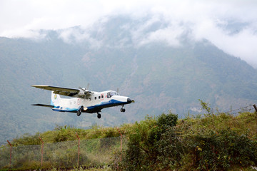 Fototapeta na wymiar The aircraft on the runway of the Tenzing-Hillary airport Lukla - Nepal, Himalayas.