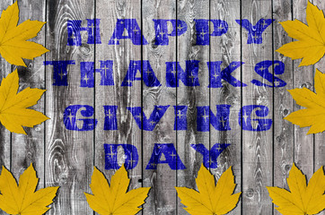 Blue Happy Thanksgiving Day written on wooden board background w