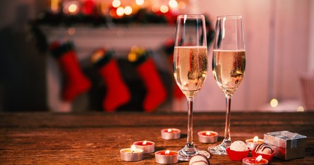 Champagne flute and gifts box on wooden table