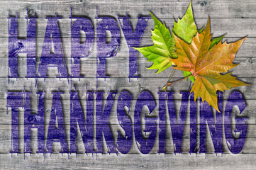 Blue Happy Thanksgiving written on wooden board background with