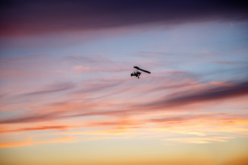 Hang glider flying in clouds
