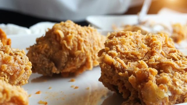 Eating Fried chicken in fast food restaurant, camera slide slow motion.
