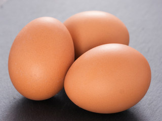 three eggs on slate background