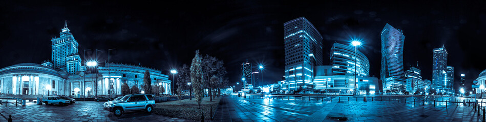 Night skyline of Warsaw with soviet era Palace of Culture and science and modern skyscrapers. 360 degree panoramic montage from 20 images