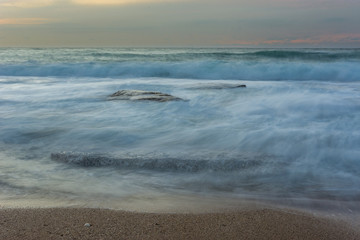 silky water of a rough sea after sunset