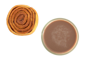 Glass of chocolate milk with a sweet roll.